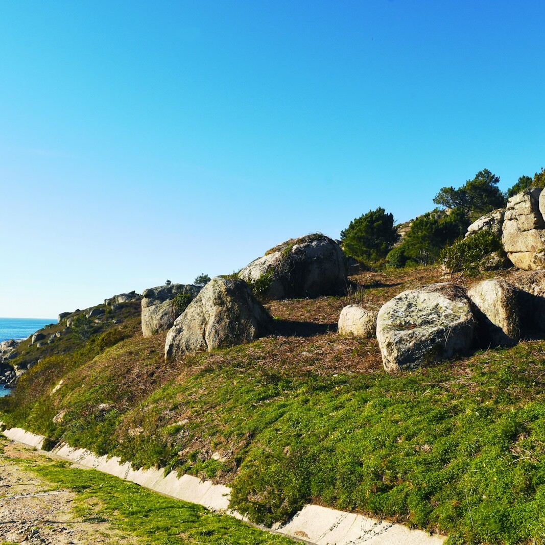 gray rock formation near body of water during daytime