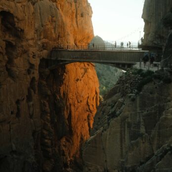a bridge over a canyon with people walking on it