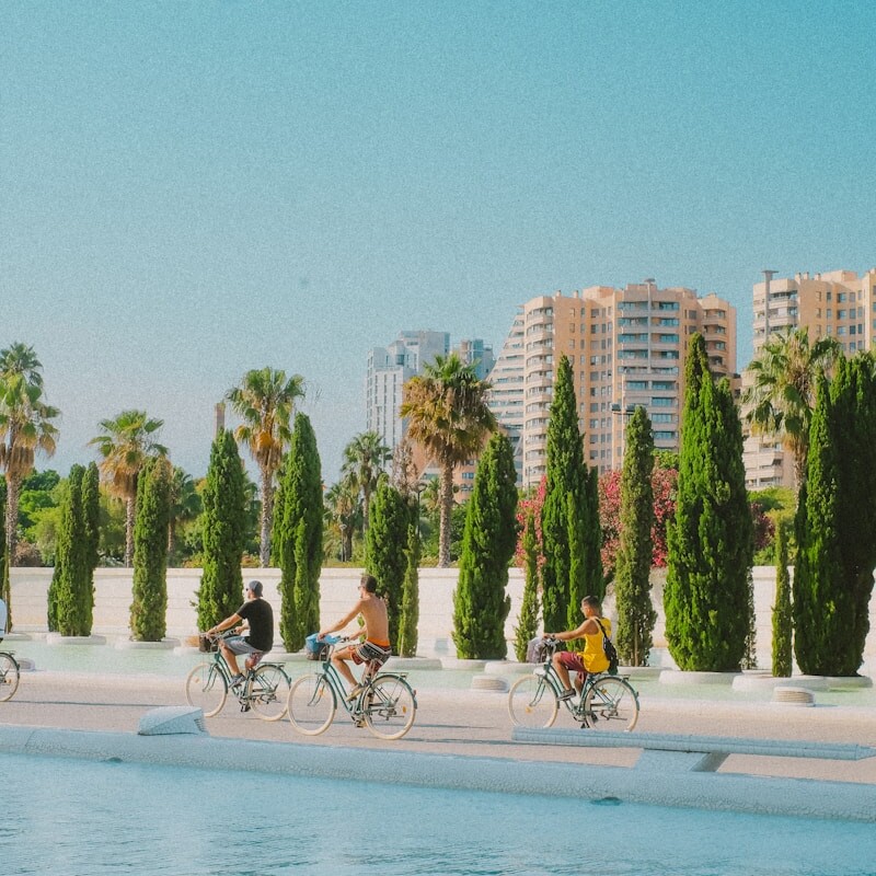 A group of people riding bikes on a beach